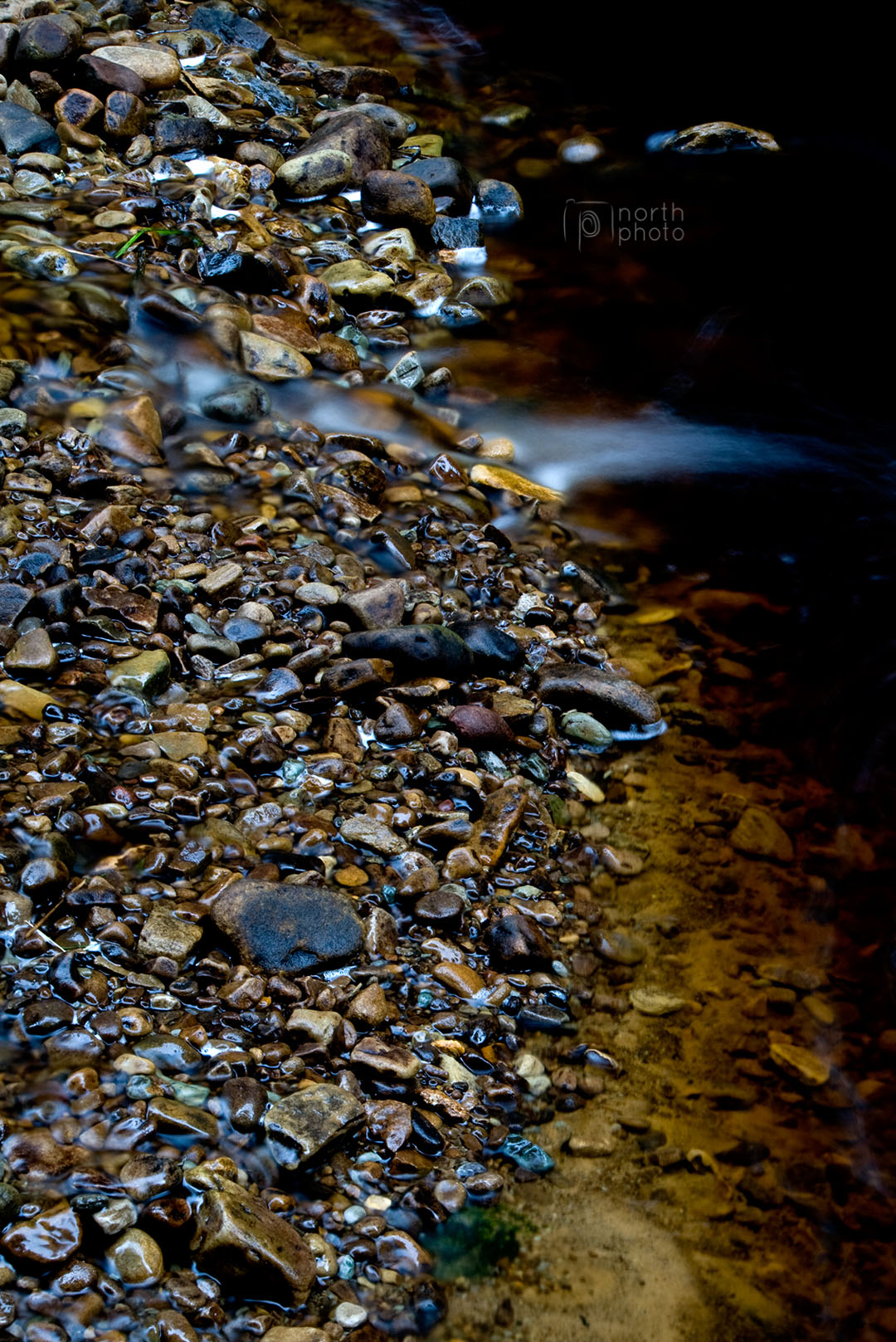 Shiny pebbles on a river bank