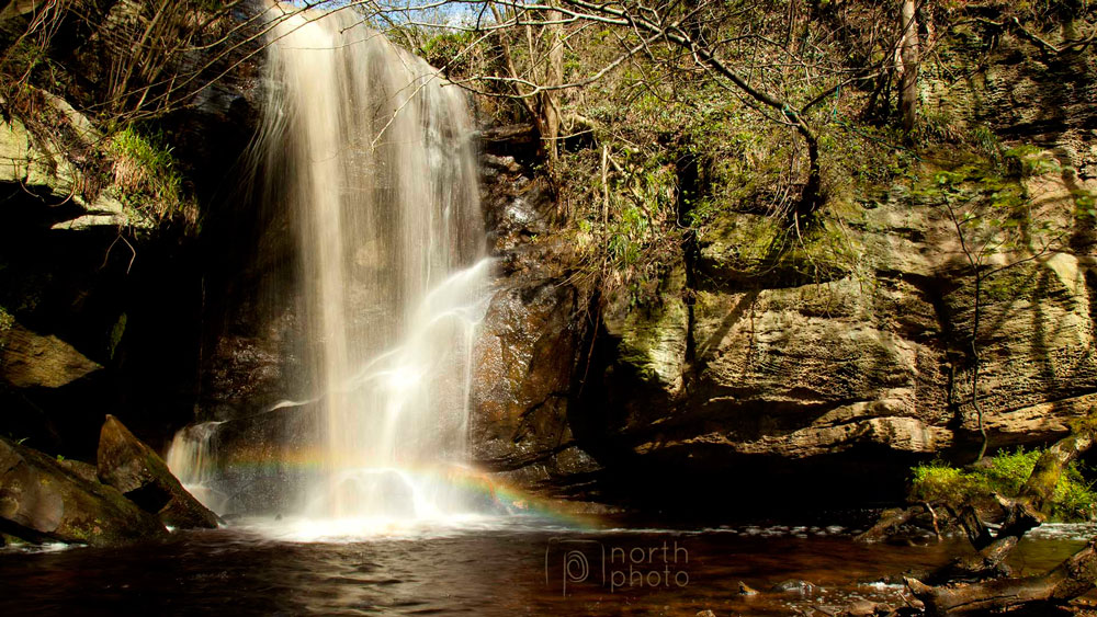 Rainbow created by the sunlight meeting Roughting Linn's spray