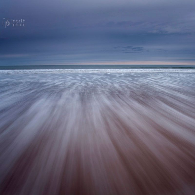 Tide rushing in on Warkworth Beack